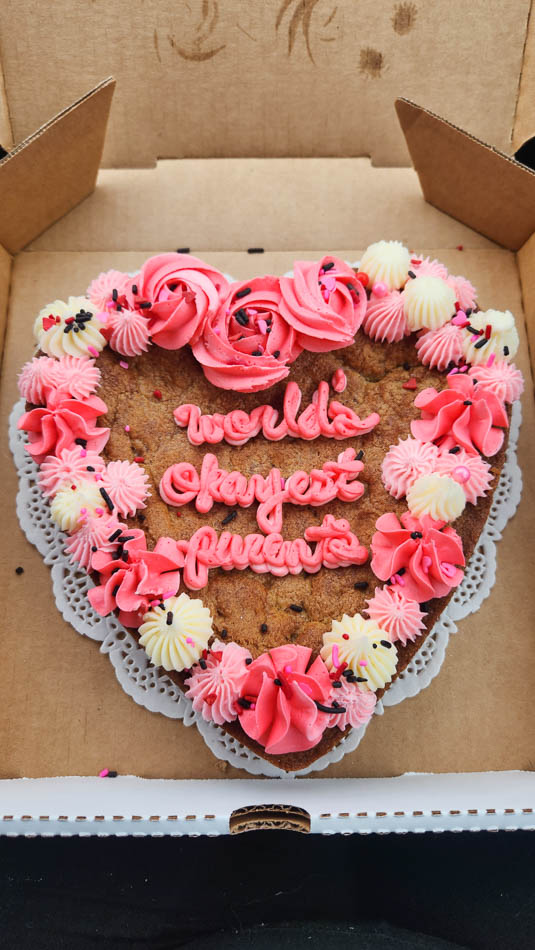 Custom heart-shaped Cookie Cake from Bae's Bakery that says "World's Okayest Parents"