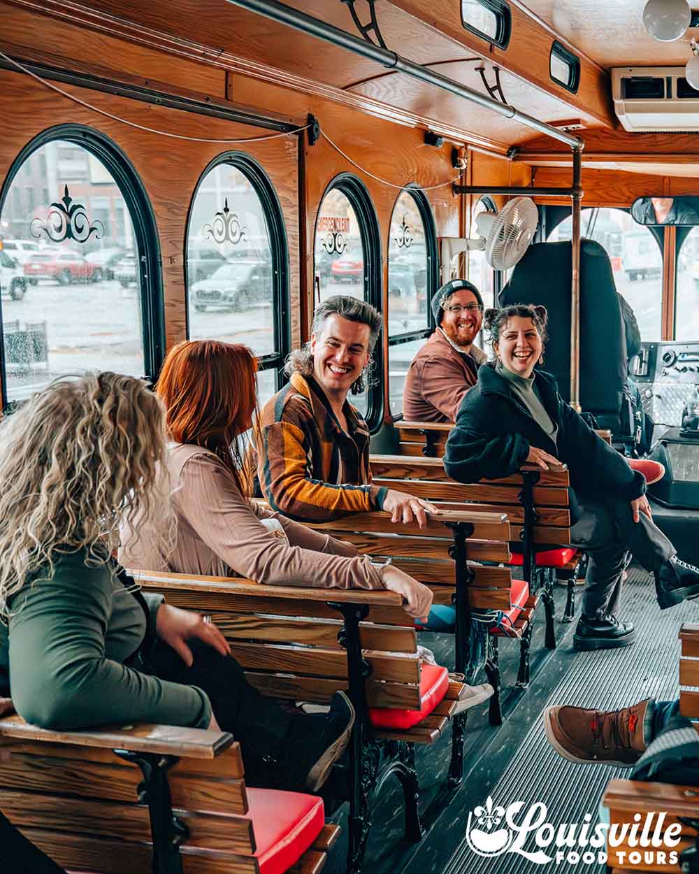 Group inside a trolley on the bourbon trolley tour by Louisville Food Tours