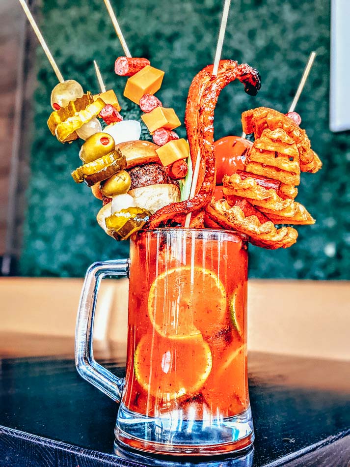 The Big A** Bloody Mary from CC's Kitchen in Louisville KY, topped with chicken wings, foot-long sausage, chese, olives, shrimp, and more.