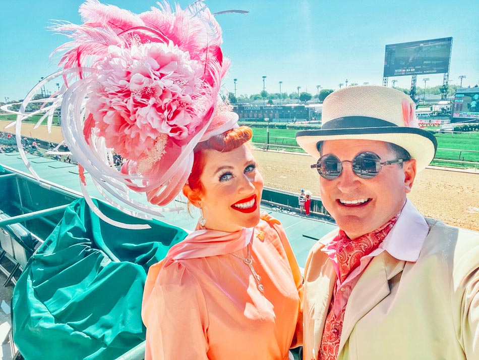 Couple with big hats at the Kentucky Derby Louisville KY.