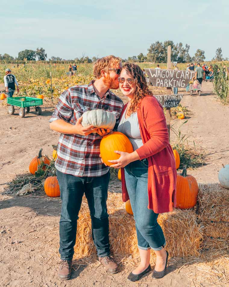 Couple at a pumpkin patch.