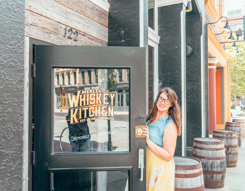 Lia Garcia opening the door to Merle's Kitchen on Whiskey Row in Louisville Kentucky