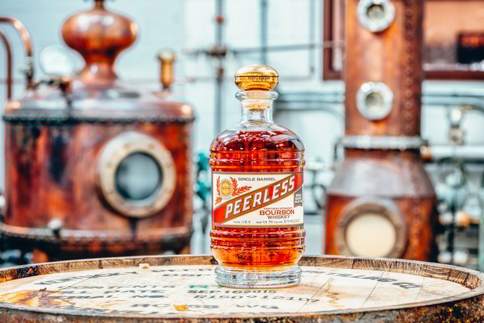 Single barrel bourbon in front of still at Kentucky Peerless Distilling Co. Louisville, KY