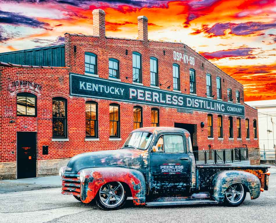Truck and facade against sunset of Kentucky Peerless Distilling Co. Louisville, KY
