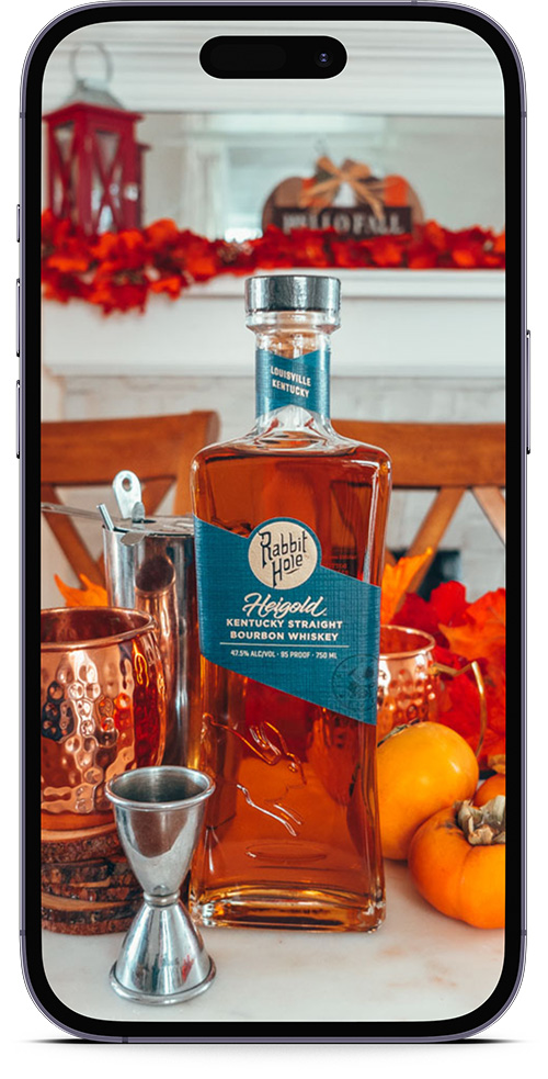 Work With Us Product Image Example - bottle of Rabbit Hole bourbon on a smartphone