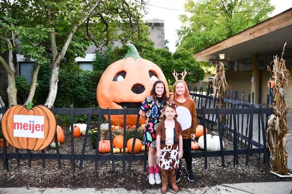 boo at the zoo louisville ky kids in front of mumpkin