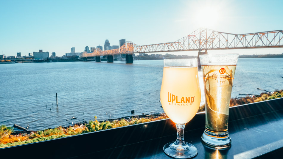 Beer from Upland Brewery in Jeffersonville, Indiana with the Louisville skyline in the background across the Ohio River.
